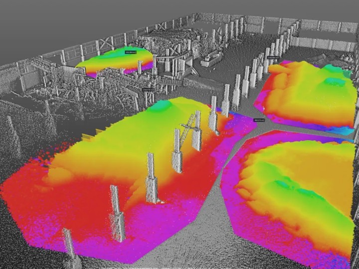 Color-graded elevation point cloud of a yard with pilings, used to calculate material volumes and surface measurements.