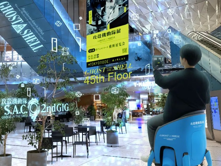 Visitor in a mall atrium seeing AR holographic panels and markers anchored to the real space through a VPS-aligned experience.