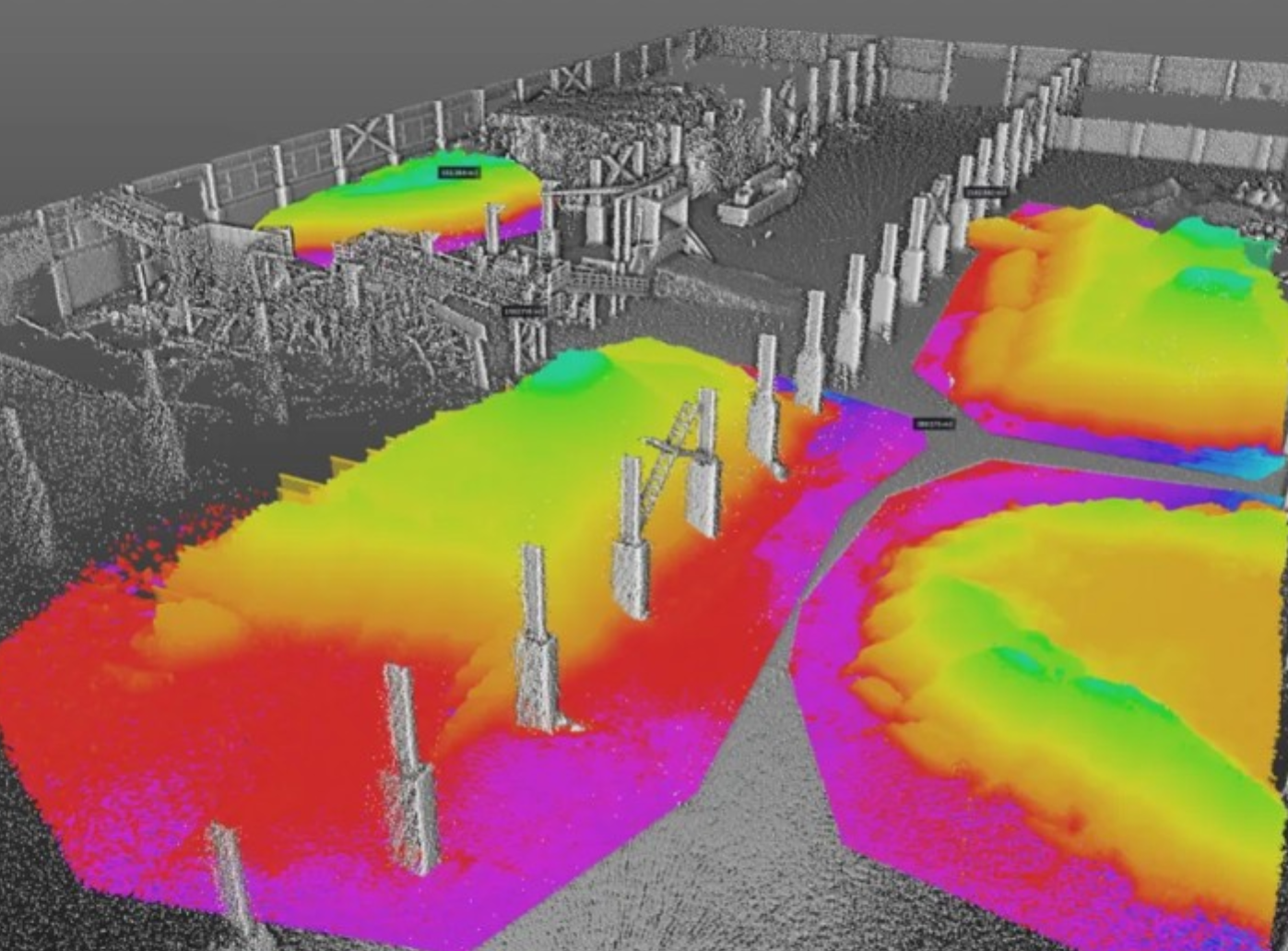 Color-graded elevation point cloud of a dock with pilings, used for surface and elevation spatial analysis.